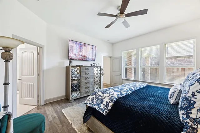 a bedroom with a bed closet and a large window