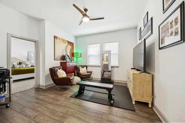 a living room with furniture and a wooden floor