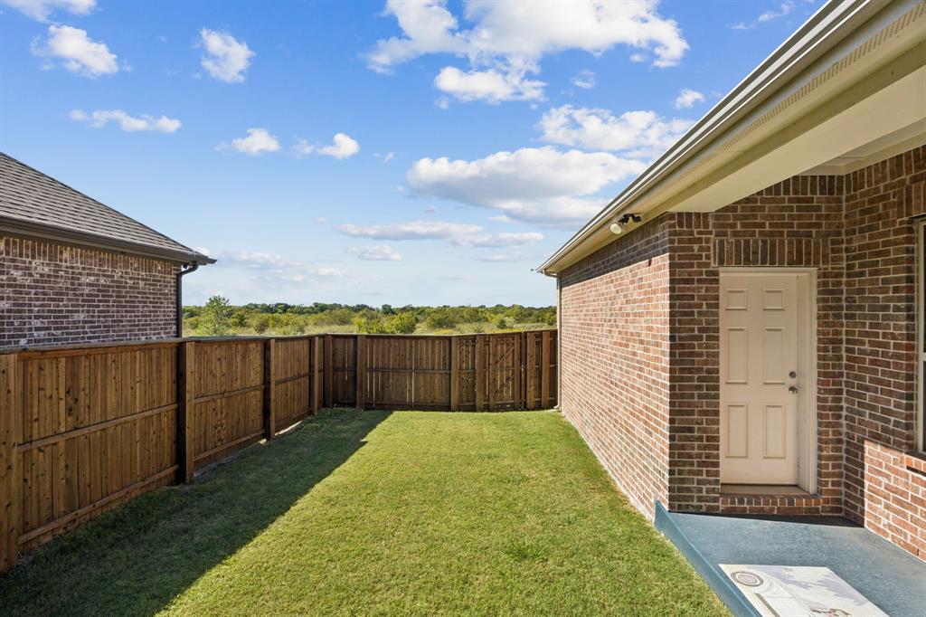 8905 Habersham Drive Rowlett, TX 75089 - Photo 26 of 31 View of fenced backyard and Open field behind.
