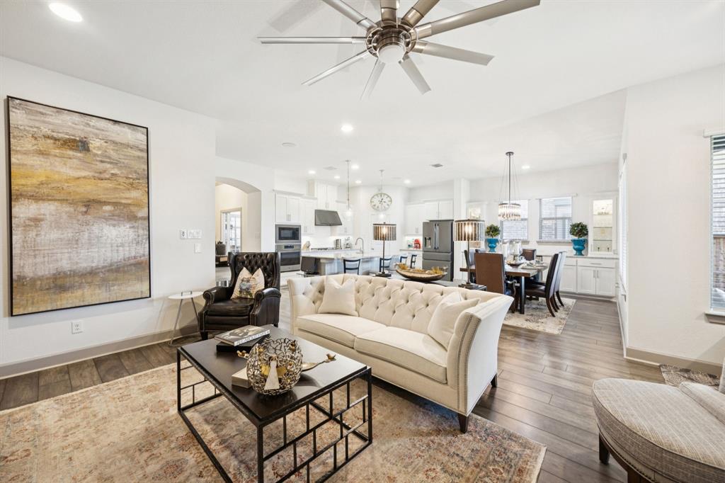 8905 Habersham Drive Rowlett, TX 75089 - Photo 4 of 31 Living room with recessed lighting, a ceiling fan, arched walkways, and dark wood-style flooring