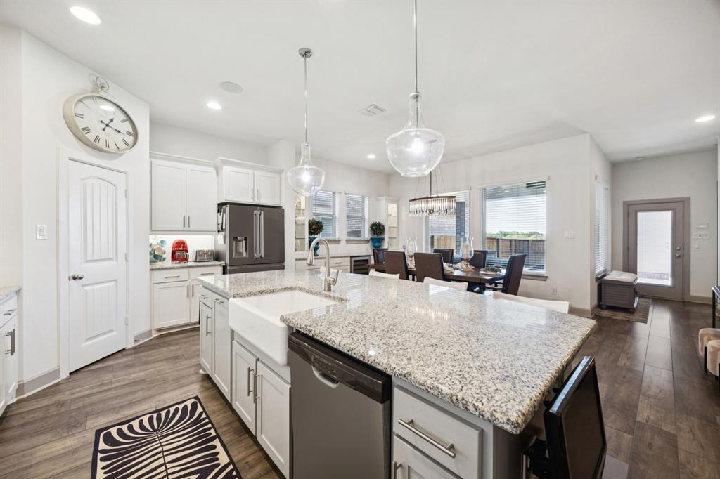 8905 Habersham Drive Rowlett, TX 75089 - Photo 8 of 31 Kitchen featuring appliances with stainless steel finishes, light stone countertops, white cabinets, and recessed lighting