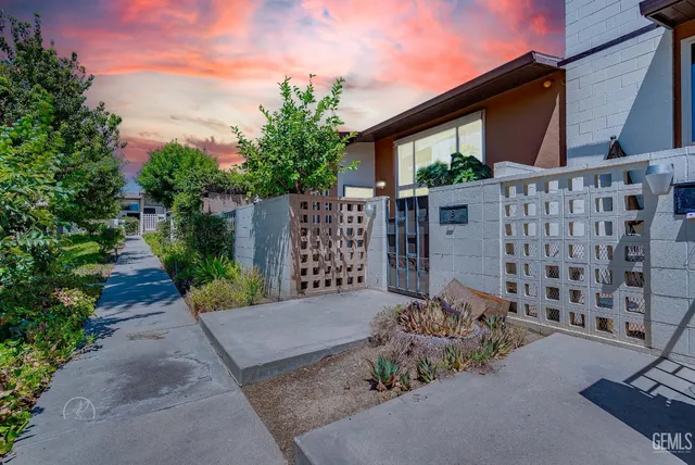 a view of a house with wooden fence