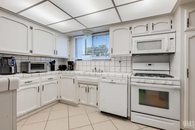 a kitchen with cabinets stainless steel appliances and a sink