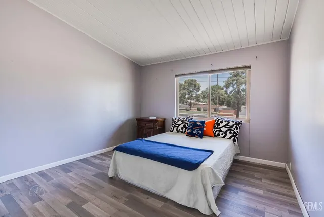 a bedroom with furniture and wooden floor