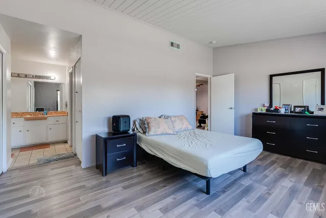 a living room with a bed furniture and a kitchen view