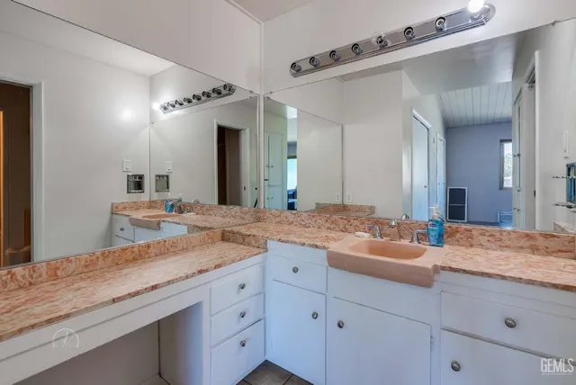 a bathroom with a granite countertop sink mirror and double