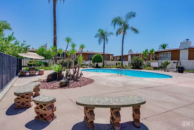 a view of a backyard with a patio table and chairs