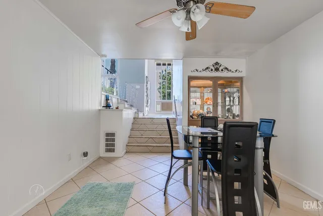 a view of a dining room with furniture and chandelier