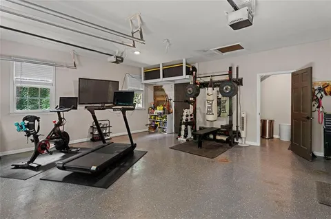 a room with gym equipment and a flat screen tv
