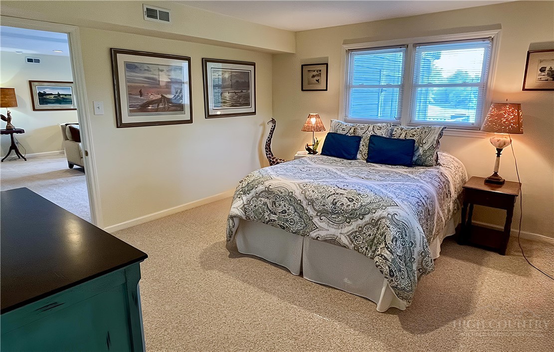 638 Ridge Road Glade Valley, NC 28627 - Photo 31 of 44 a bed room with a bed and a painting on the wall