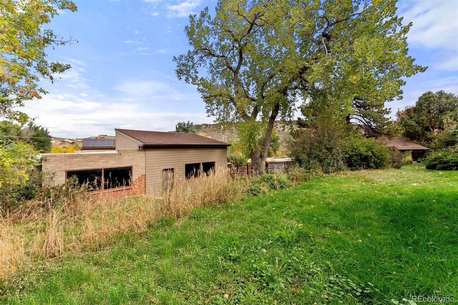 229 Highway 8 Morrison, CO 80465 - Photo 32 of 34 a view of house with yard and trees