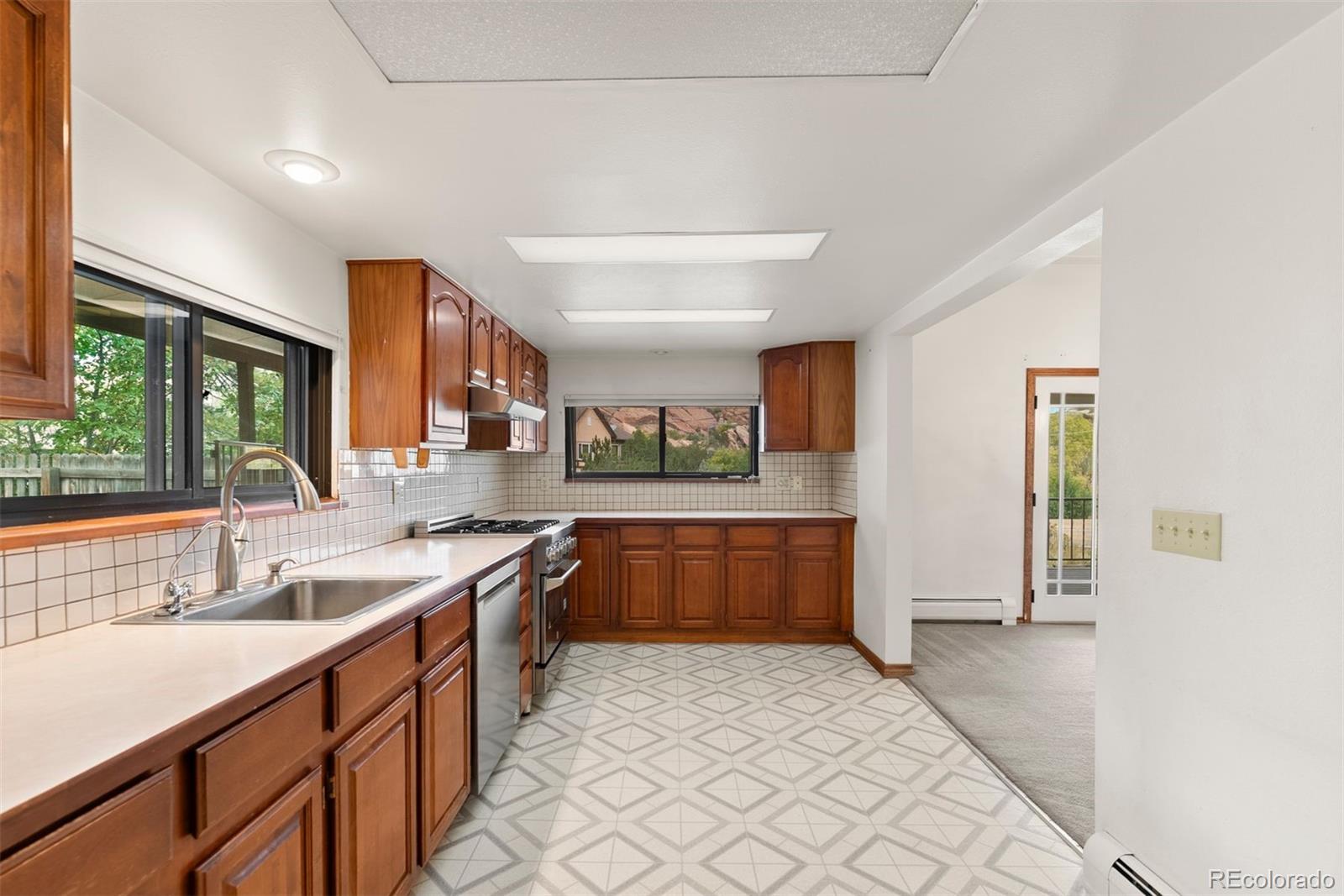 229 Highway 8 Morrison, CO 80465 - Photo 6 of 34 a kitchen with stainless steel appliances granite countertop a sink and cabinets