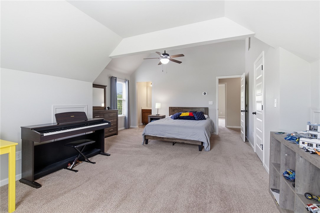 138 Buckland Drive Anderson, SC 29621 - Photo 34 of 49 An inviting bedroom features a vaulted ceiling, providing an airy and spacious atmosphere.