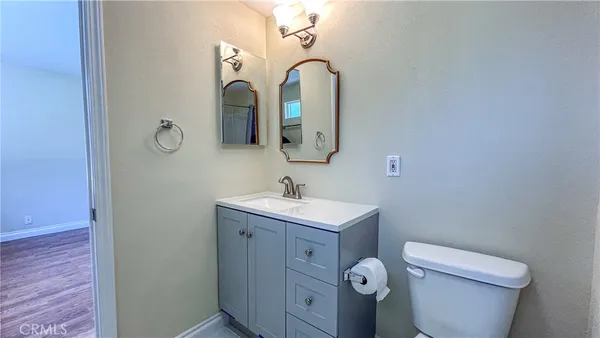 a bathroom with a double vanity sink toilet mirror and shower
