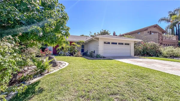 a view of a house with a garden and yard