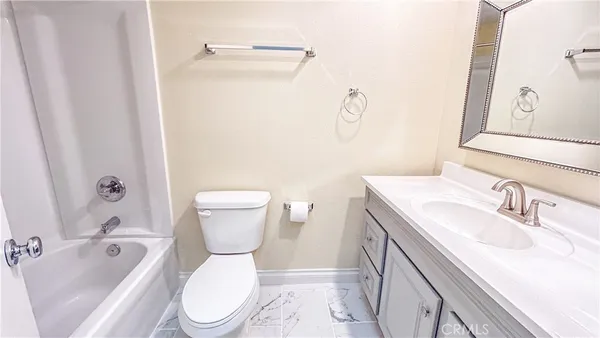 a bathroom with a sink toilet vanity and shower