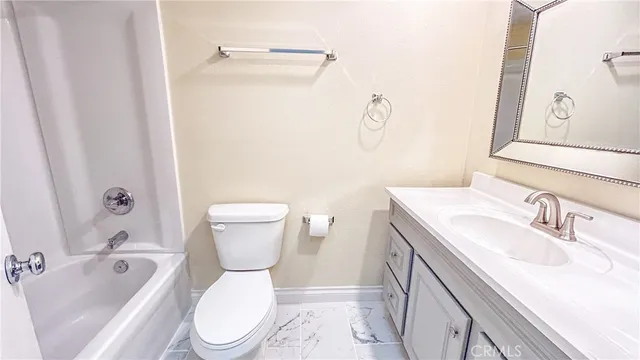 a bathroom with a sink toilet vanity and shower