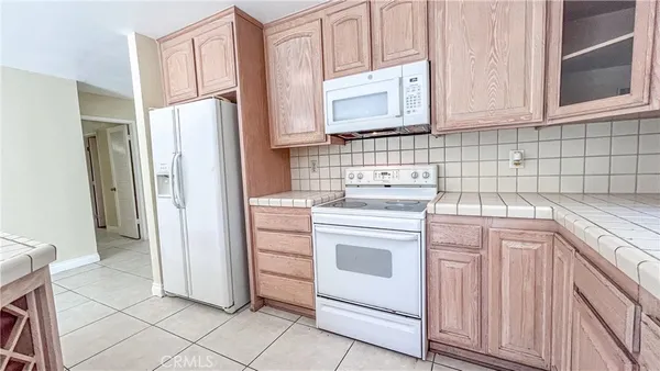 a kitchen with a sink window and cabinets