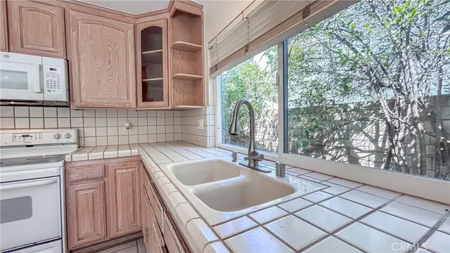 a kitchen with a stove sink and cabinets