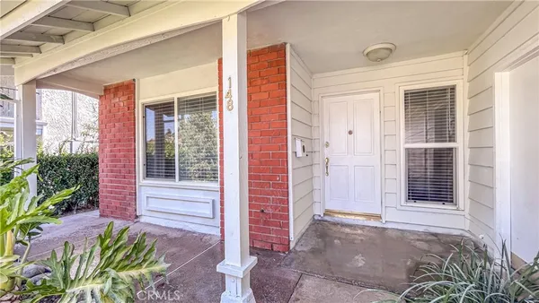 a view of a house with a potted plant and a large window