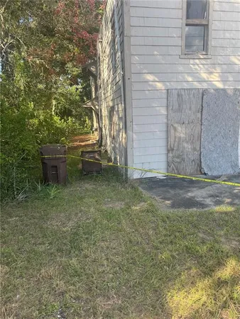a backyard of a house with fountain table and chairs