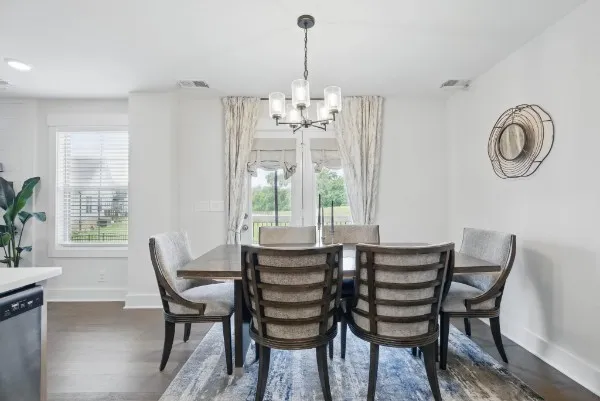 a dining room with furniture and window