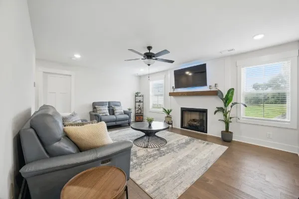 a living room with furniture a fireplace and a flat screen tv