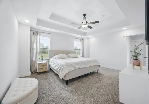 a living room with a bed furniture and a window