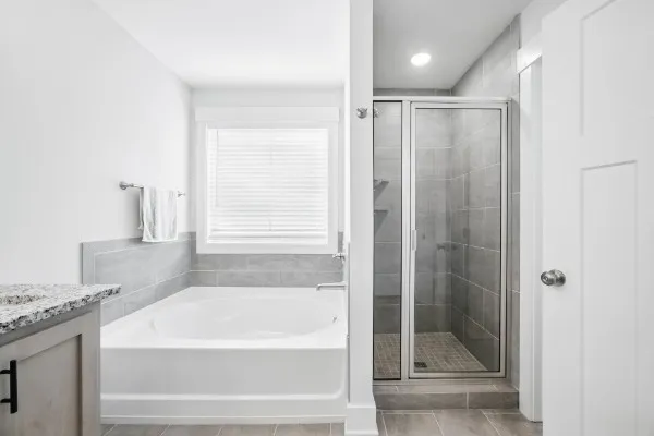 a bathroom with a shower a bathtub and a shower