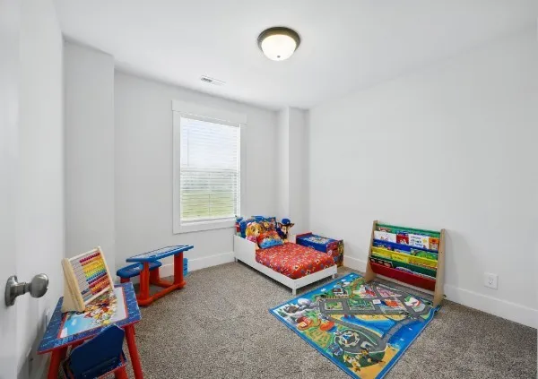 a living room with furniture and a book shelf