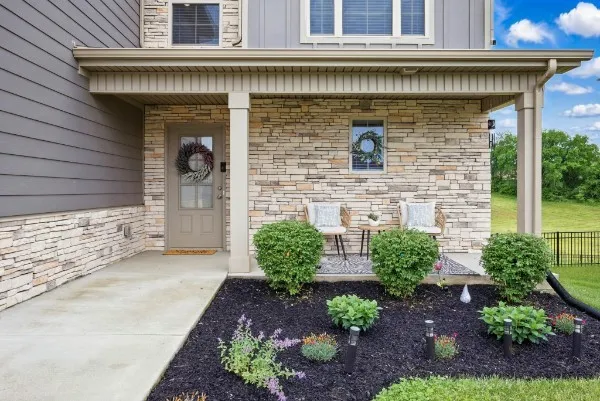 a front view of a house with garden