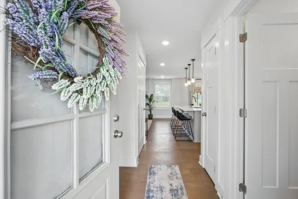 a view of a hallway with wooden floor and chair
