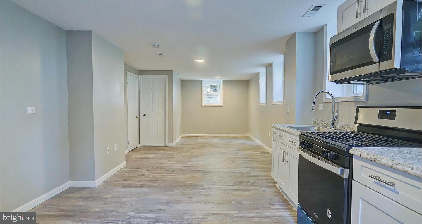 6110 41st Avenue, Unit C Hyattsville, MD 20782 - Photo 2 of 11 a kitchen with stainless steel appliances granite countertop a stove and a microwave