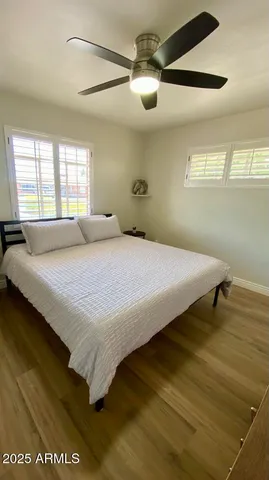 a bedroom with a bed and a large window