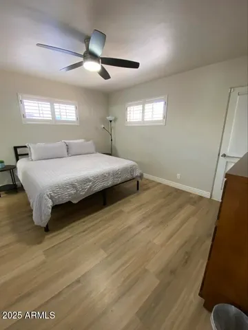 a spacious bedroom with a bed and window