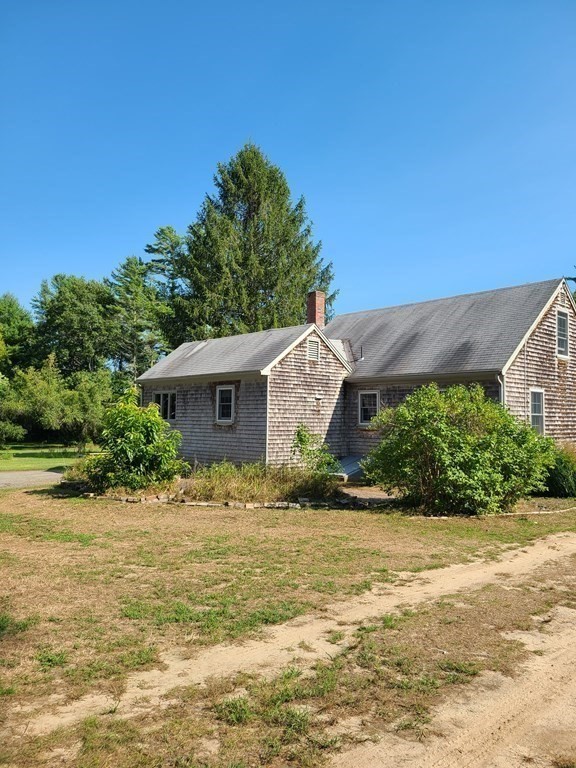 199 New Bedford Road Rochester, MA 02770 - Photo 17 of 20 a front view of a house with a yard