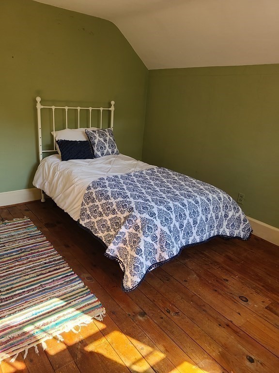 199 New Bedford Road Rochester, MA 02770 - Photo 10 of 20 a bed sitting in a bedroom next to a window
