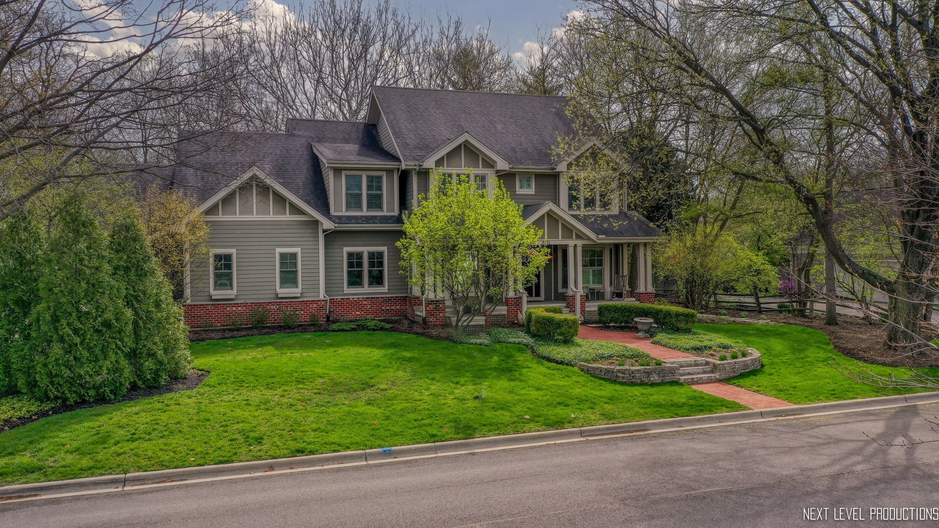 801 Meadows Road Geneva, IL 60134 - Photo 5 of 14 a front view of a house with a garden and trees