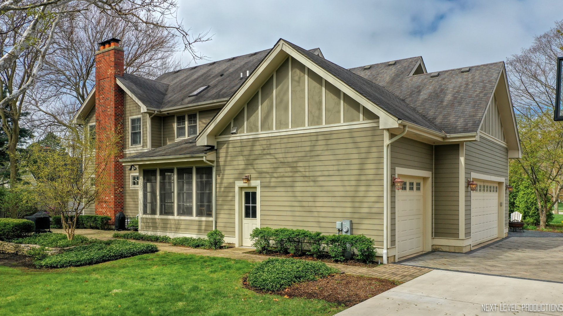801 Meadows Road Geneva, IL 60134 - Photo 9 of 14 a view of a house with brick walls and a yard with plants