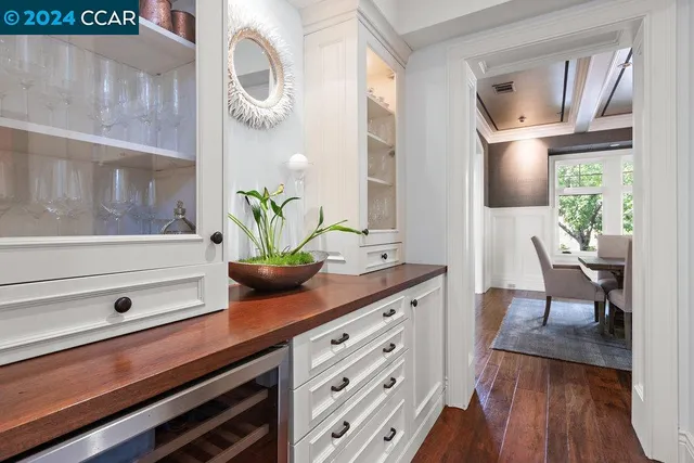 a view of a dining room with furniture a chandelier and wooden floor
