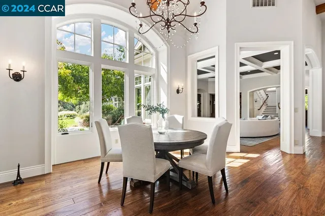 a living room with a pool table flat screen tv and windows
