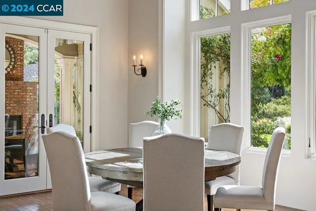 a living room with furniture a fireplace and a large window