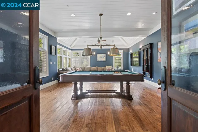a bathroom with a granite countertop sink and a window