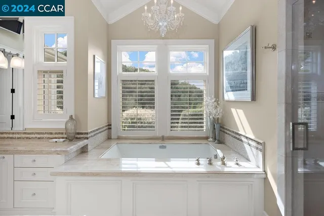 a view of a hallway with furniture and windows