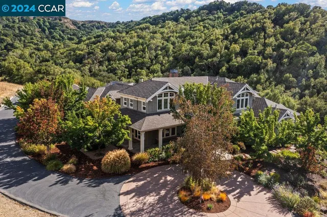 a front view of a house with a yard and a sitting area