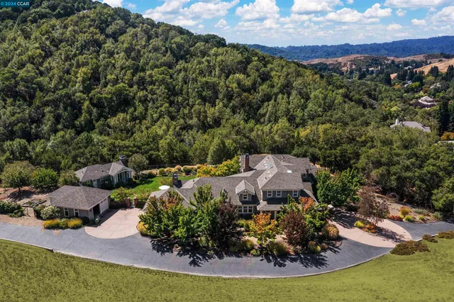 a view of backyard of house with seating space