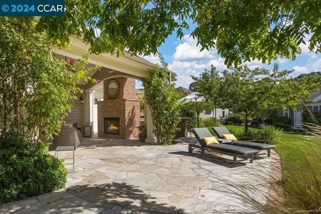 a living room with furniture a large window and a fireplace