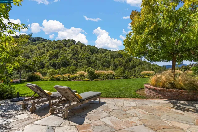 a kitchen with stainless steel appliances granite countertop a stove and a wooden floors