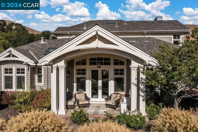 a view of a patio with couches table and chairs and potted plants
