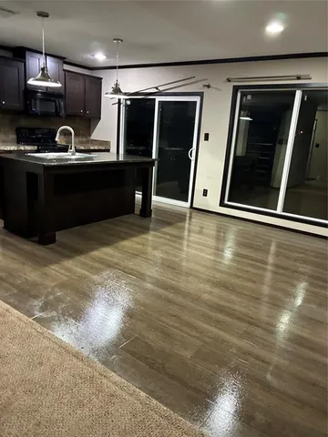 a view of kitchen with refrigerator sink and wooden floor
